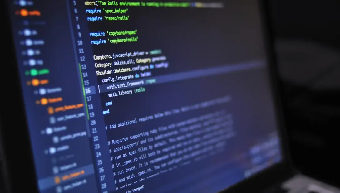 Tela escura exibindo linhas de código coloridas